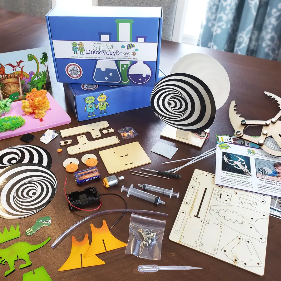 A royal-blue STEM Discovery Box with the robot-and-flask logo