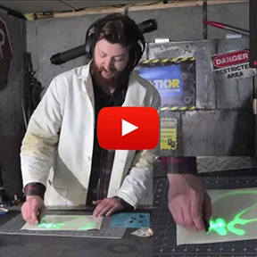 A YouTube video still showing a presenter demonstrating a glow-in-the-dark STEM Discovery Boxes project