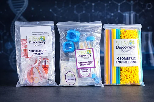 Three labeled zip-top bags from STEM Discovery Boxes, one per project: Circulatory System, Fizzing Color Chemistry and Geometric Engineering